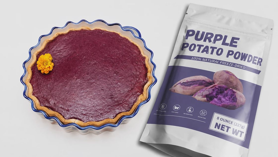 A baked purple sweet potato tart in a fluted dish next to a resealable pouch of purple potato powder.